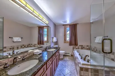 a bathroom with two sinks and a tub and a shower at R110 Timber Ridge in Kirkwood