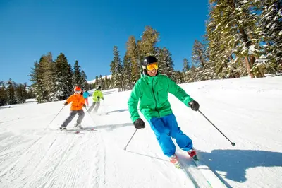 a group of people skiing down a snow covered slope at L306 Kirkwood Lodge in Kirkwood