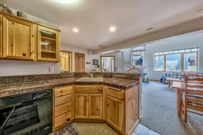 a kitchen with wooden cabinets and a sink at L306 Kirkwood Lodge in Kirkwood