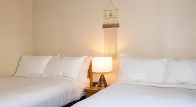 two beds sitting next to each other in a room at Gull Lake Lodge in June Lake