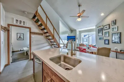 a kitchen with a sink and a staircase at 3302 Sun Meadows in Kirkwood