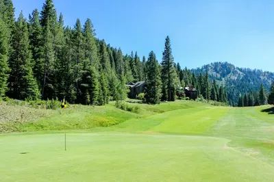 a view of a golf course with a green at Resort at Squaw Creek 808 in Olympic Valley