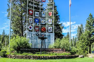 a tall glass building with a sign in front of it at Resort at Squaw Creek 808 in Olympic Valley