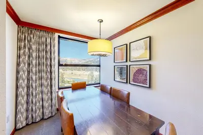 a dining room with a table and a large window at Resort at Squaw Creek 808 in Olympic Valley