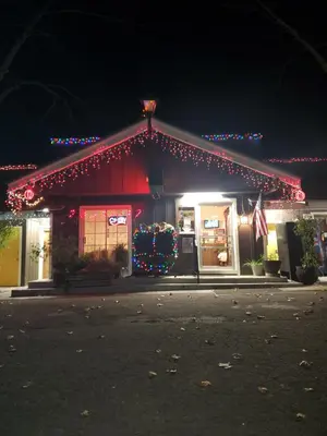 a store front with christmas lights on it at night at The Gold Lodge in Sonora