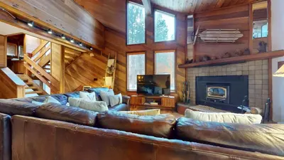 a large leather couch in a living room with a fireplace at Tennis Village 14 Townhouse in Mammoth Lakes