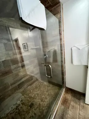 a shower with a glass door in a bathroom at June Lake Villager in June Lake