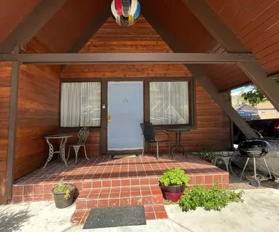 a screened in porch with a grill and a patio at June Lake Villager in June Lake