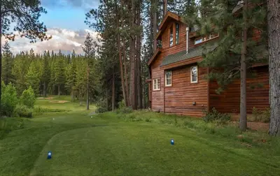 a log cabin with a golf ball on the green at Luxury Lodgepole Home at Northstar in Truckee