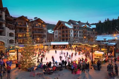 a group of people skating on an ice rink in a resort at Luxury Lodgepole Home at Northstar in Truckee