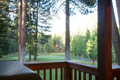 a screened in porch with a view of the woods at Luxury Lodgepole Home at Northstar in Truckee