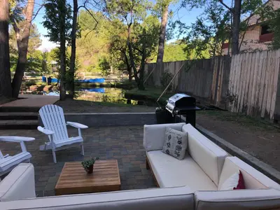 a patio with a couch and two chairs and a grill at Eastside Guesthouse and Bivy in Bishop