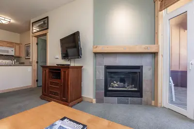 a living room with a fireplace and a tv at Sunstone 326 in Mammoth Lakes