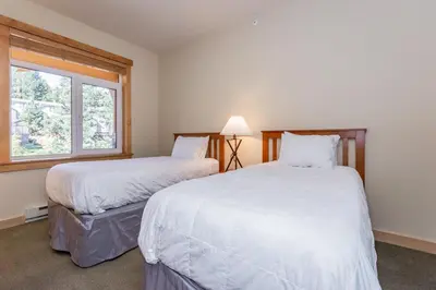 a bedroom with two beds and a window at Sunstone 326 in Mammoth Lakes