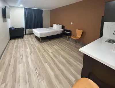 a hotel room with a bed and a desk at Studio 6 Suites Cameron Park, CA Folsom in Cameron Park