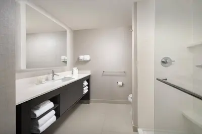 a white bathroom with a sink and a shower at Residence Inn by Marriott Modesto North in Modesto