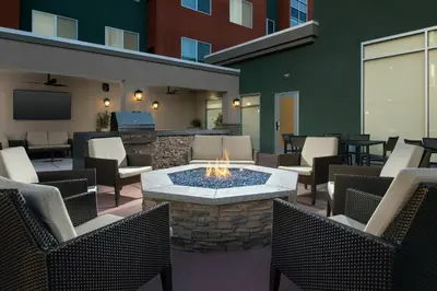 a patio with a fire pit with chairs and tables at Residence Inn by Marriott Modesto North in Modesto