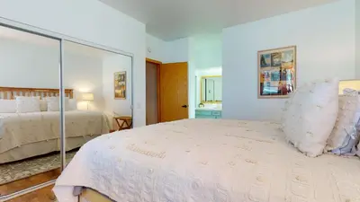 a bedroom with a large bed and a mirror at Snowcreek 887 Condo in Mammoth Lakes