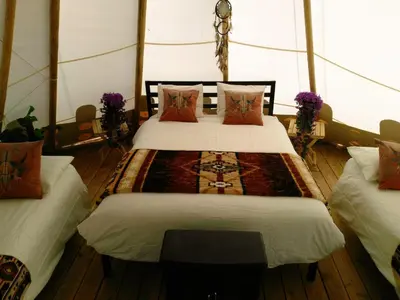 a bedroom with two beds in a tent at Olancha RV Park and Motel in Olancha