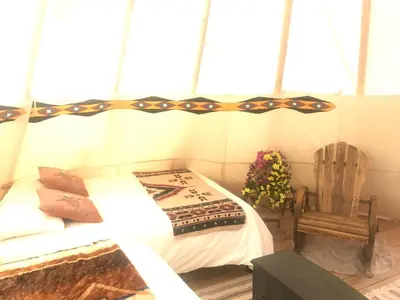 a bedroom with a bed and a wooden chair at Olancha RV Park and Motel in Olancha