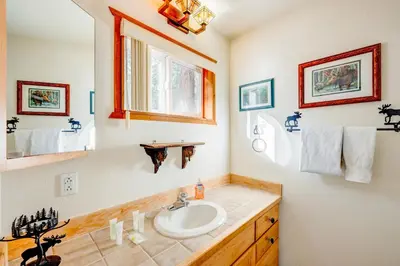 a bathroom with a sink and a mirror at Peaceful Forest Retreat in Carnelian Bay