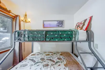 a bunk bed in a room with a window at Peaceful Forest Retreat in Carnelian Bay