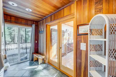 a room with wooden walls and a door with a window at Peaceful Forest Retreat in Carnelian Bay