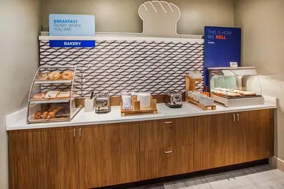 a bakery with a counter with donuts on it at Holiday Inn Express & Suites - Tulare by IHG in Tulare