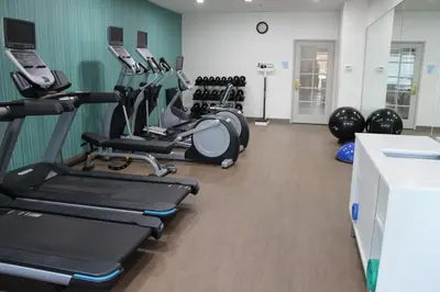 a gym with several treadmills and exercise bikes at Holiday Inn Express & Suites - Tulare by IHG in Tulare