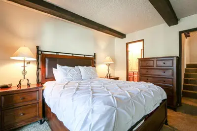 a bedroom with a large bed and two dressers at Chamonix Condo 94 Condo in Mammoth Lakes