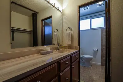 a bathroom with a sink and a mirror and a toilet at Chamonix Condo 94 Condo in Mammoth Lakes