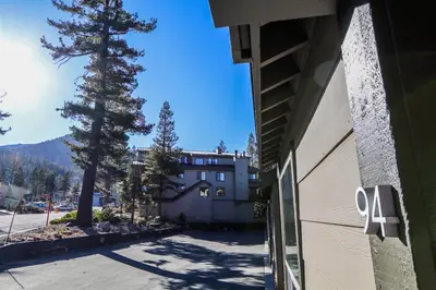 a building with a tree in front of a building at Chamonix Condo 94 Condo in Mammoth Lakes