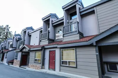 a building with a red door on a street at Chamonix Condo 94 Condo in Mammoth Lakes