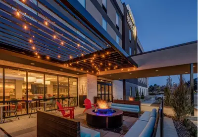 an outdoor patio with a fire pit in front of a building at Home2 Suites By Hilton Reno in Reno