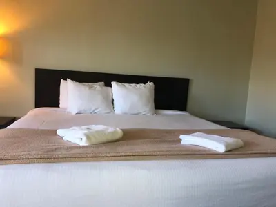a bed with two towels sitting on top of it at Hotel Elevation in South Lake Tahoe