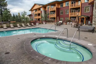 a swimming pool in front of a apartment complex at Sunstone #126 Condo in Mammoth Lakes
