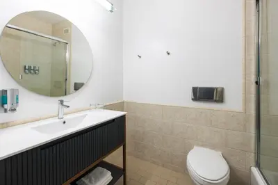 a bathroom with a sink and a toilet and a mirror at Gravity Haus Truckee-Tahoe in Truckee