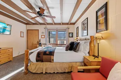 a bedroom with a bed and a ceiling fan at Mother Nature's Inn in Tahoe City