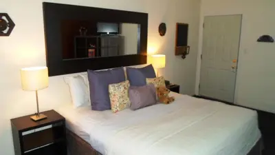 a bedroom with a large white bed with pillows at Paradice Motel in South Lake Tahoe
