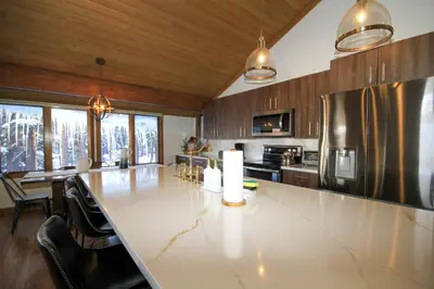 a large kitchen with a large white counter top at Mountainback 116 LoftCorner in Mammoth Lakes