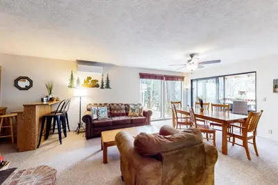 a living room and dining room with a couch and a table at Creekside Cabin in Groveland
