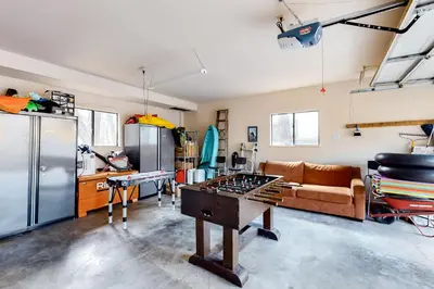 a living room with a ping pong table in it at Creekside Cabin in Groveland