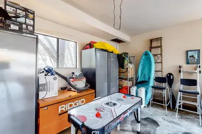 a room with a refrigerator and a table and chairs at Creekside Cabin in Groveland