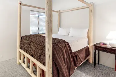 a bedroom with a wooden four poster bed at Silver Star Retreat in Ponderosa Fairway Estates