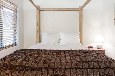 a bedroom with a large bed with a wooden headboard at Silver Star Retreat in Ponderosa Fairway Estates