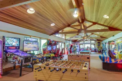 a room with many arcade games and tables at Silver Star Retreat in Ponderosa Fairway Estates