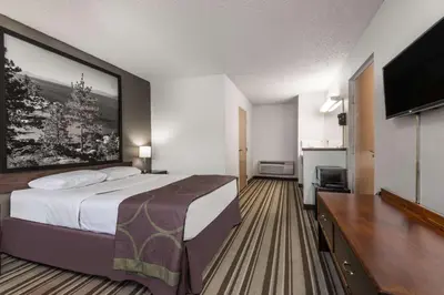 a hotel room with a bed and a flat screen tv at Super 8 by Wyndham Fernley in Fernley