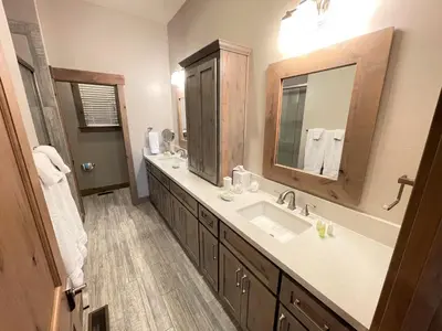 a bathroom with two sinks and a large mirror at Saint Bernard - Luxurious Upscale Comfy Mountain Retreat Hot Tub Gas BBQ with Level 2 EV Connection in Truckee