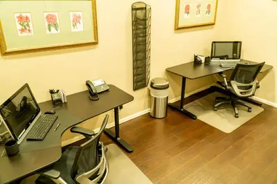 an office with two desks with a computer and a phone at Hotel Piccadilly in Fresno