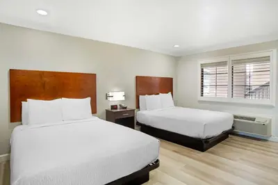 a hotel room with two beds and a window at Best Western Inn in Merced